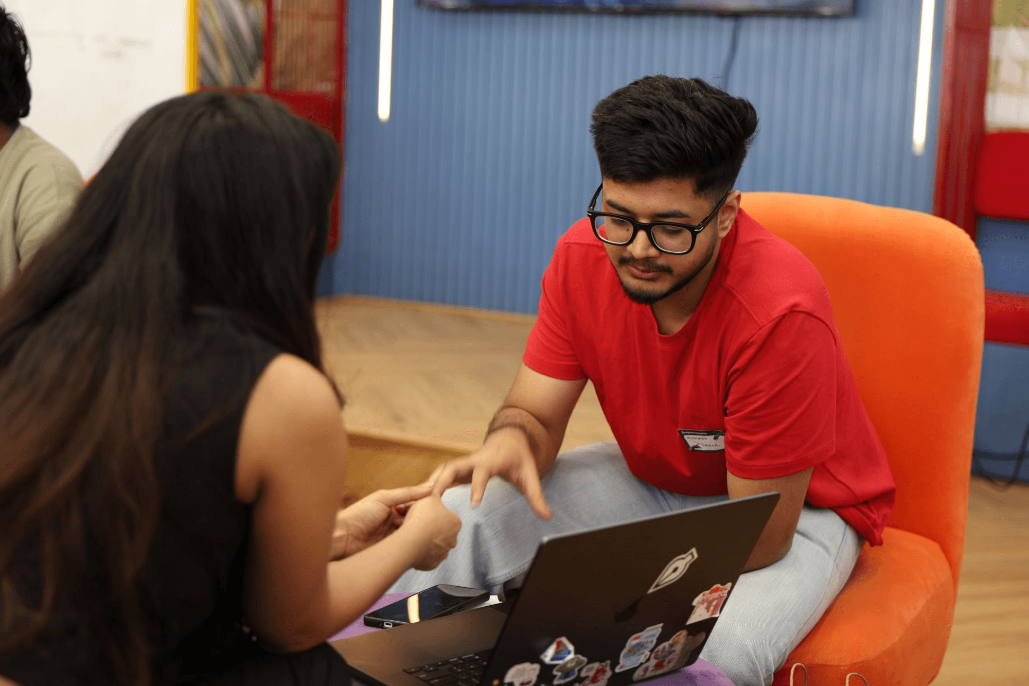 Sameer talking through an idea over his laptop at a design session